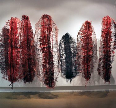 Emissaries. Handmade paper, dye, yarn and burlap. 2011