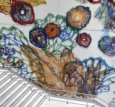 an ætiology of things. Hand-painted ceramic pigments on etched glass. 43'x140'. 2026